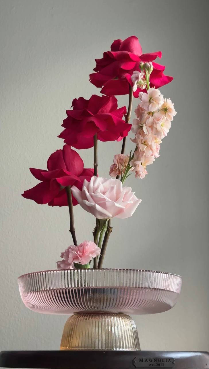 Deep red roses in an ikebana bowl